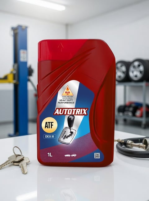 Red bottle of Autotrix ATF DEX III automatic transmission fluid on a workshop table with car lift and wheels visible in background